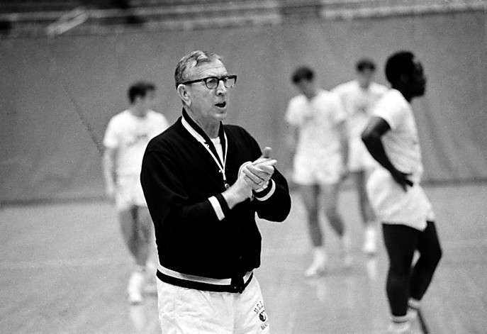 John Wooden claps his hands in encouragement of his players in a practice session